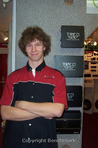 Benchmark Auto Sound employee posing with Treo speakers