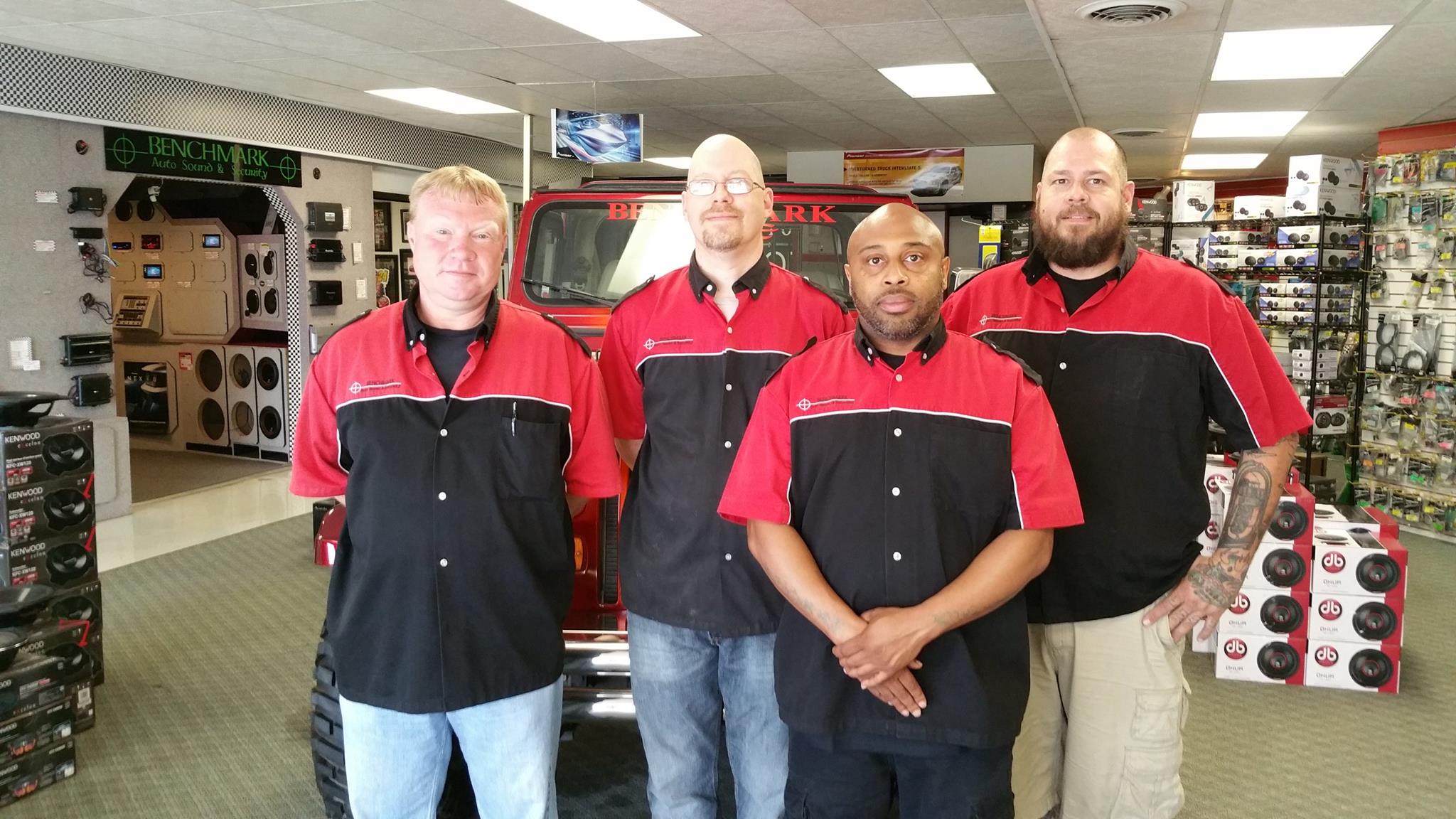 Four employees photographed in the Benchmark Auto Sound store