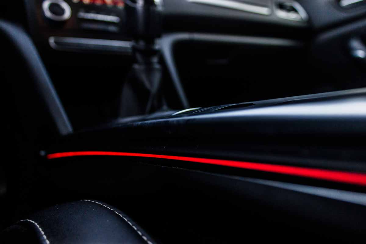 Automotive interior red LED strip lighting installed by Hear Me Coming Audio